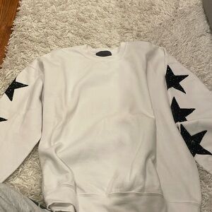 White crewneck with black stars 
Slightly worn 
Medium